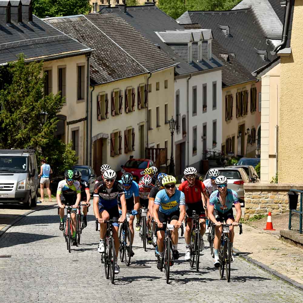Cyclists are cycling on city streets gran fondo Luxembourg