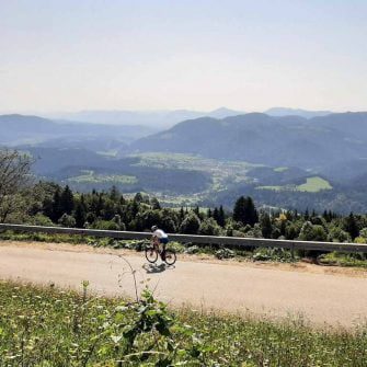 A cyclist rides on a mountain road on the Slovenian Alps cycling holidays