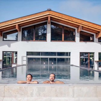 The couple bathe in the swimming pool of the Austrian Alps Hotel Das Walchsee Sportresort