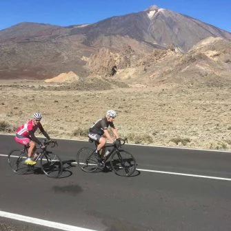 Two cyclists of cycle coaching cycling on the road