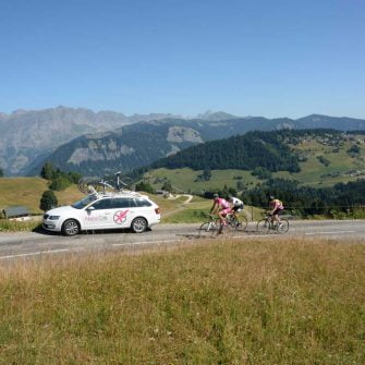 Cyclists are cycling coaching practicing on a hilly road
