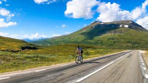 Cyclist cycling in Swedish lapland on Midnight Sun Randonnee