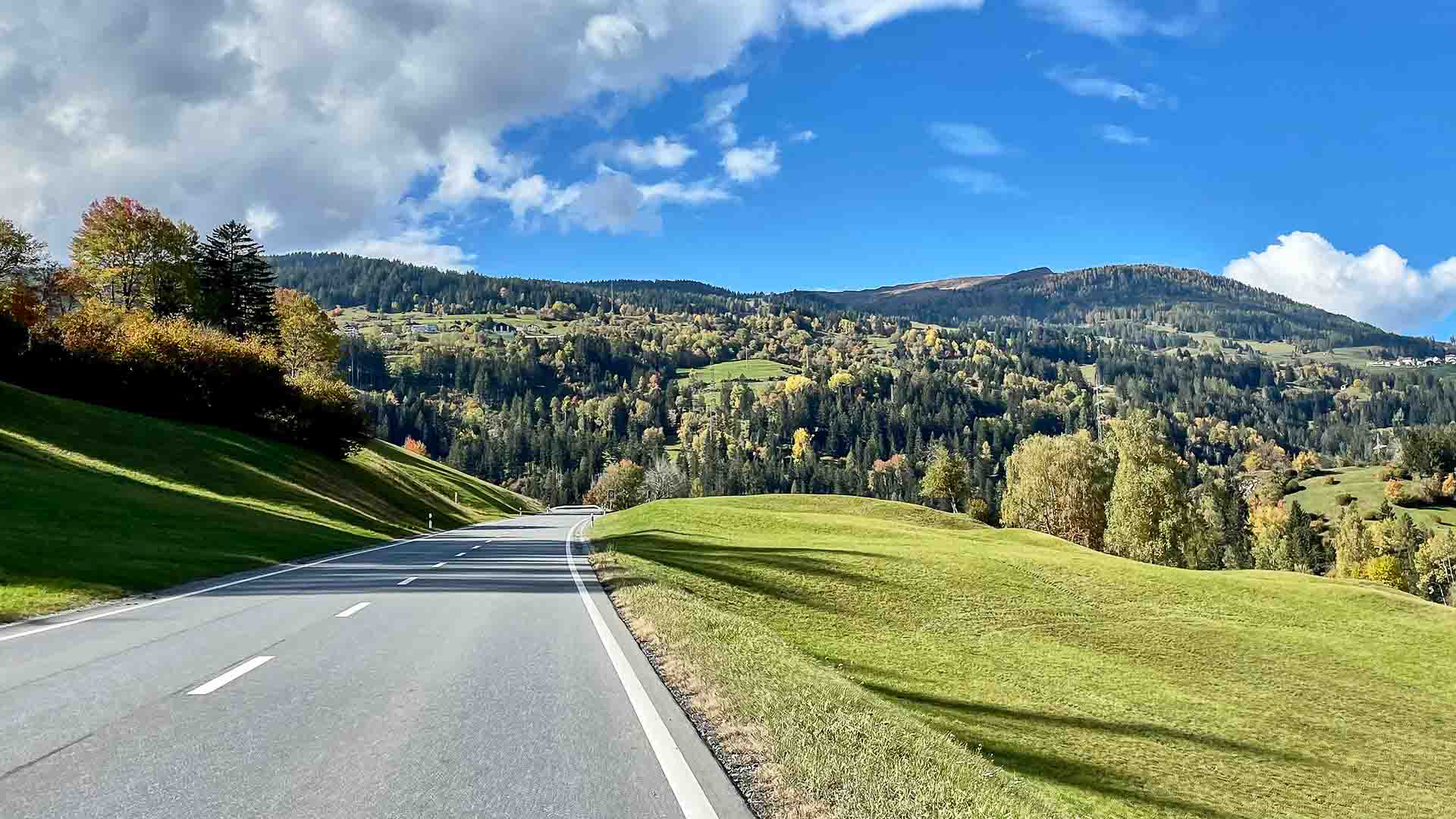Road through Swiss Alpine meadows