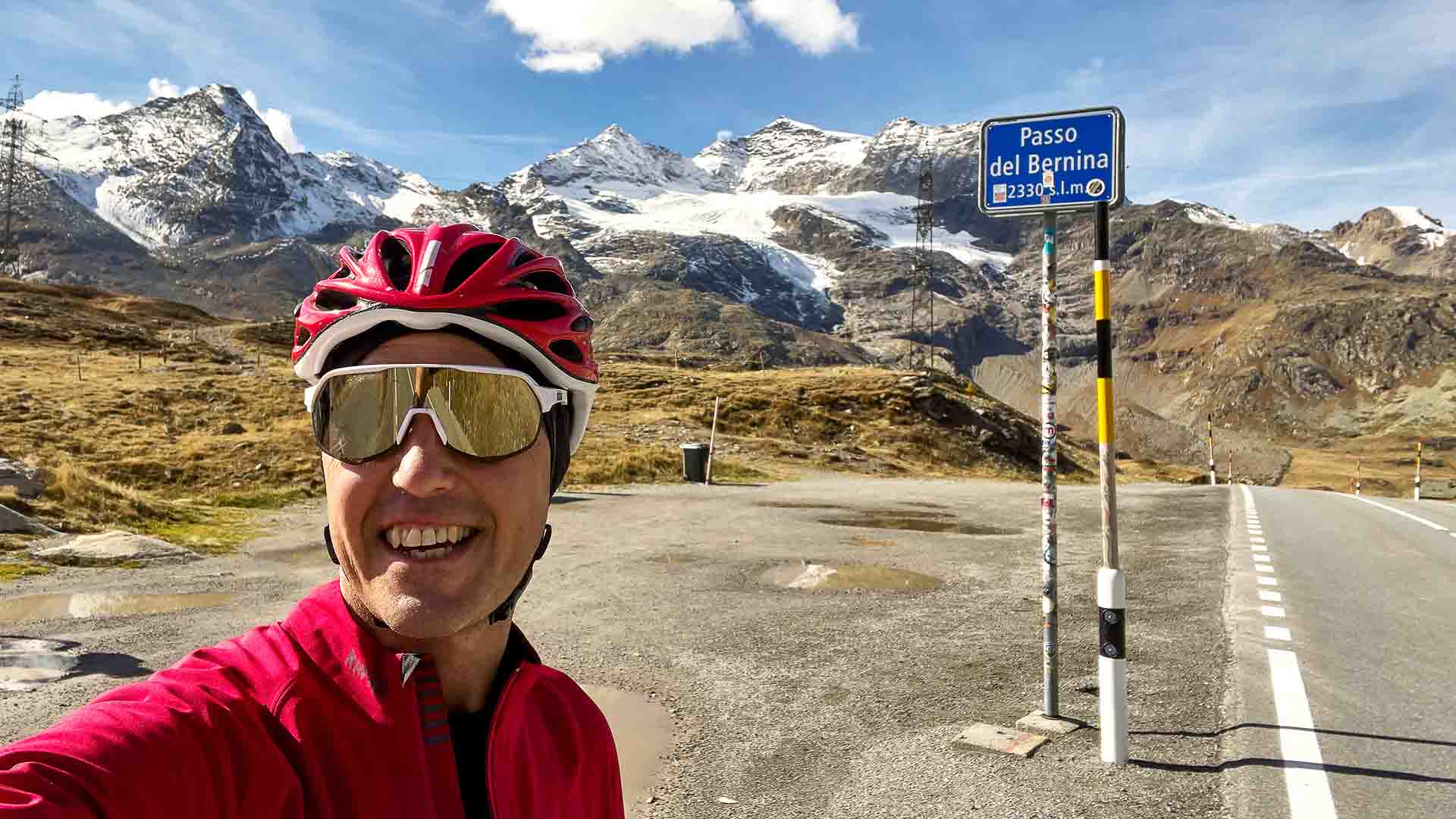Cyclist at the top of the Bernina Pass, Switzerland