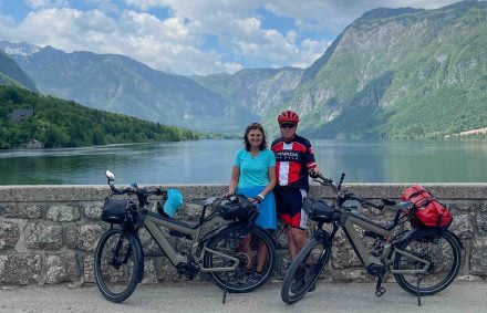Cyclists on an ebike tour by a lake in Slovenia