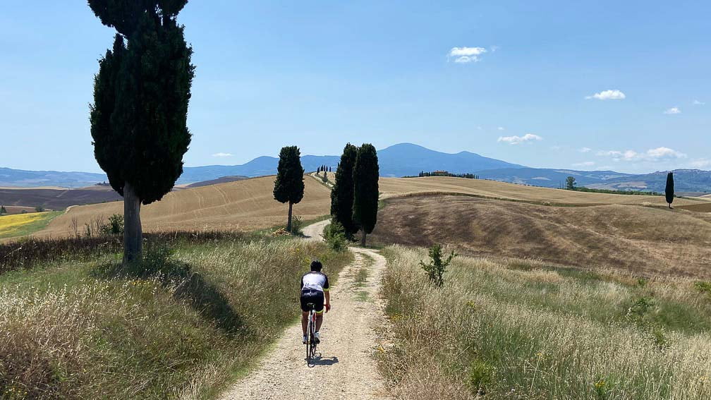 Cycling on the white roads of Tuscany surrounded by countryside