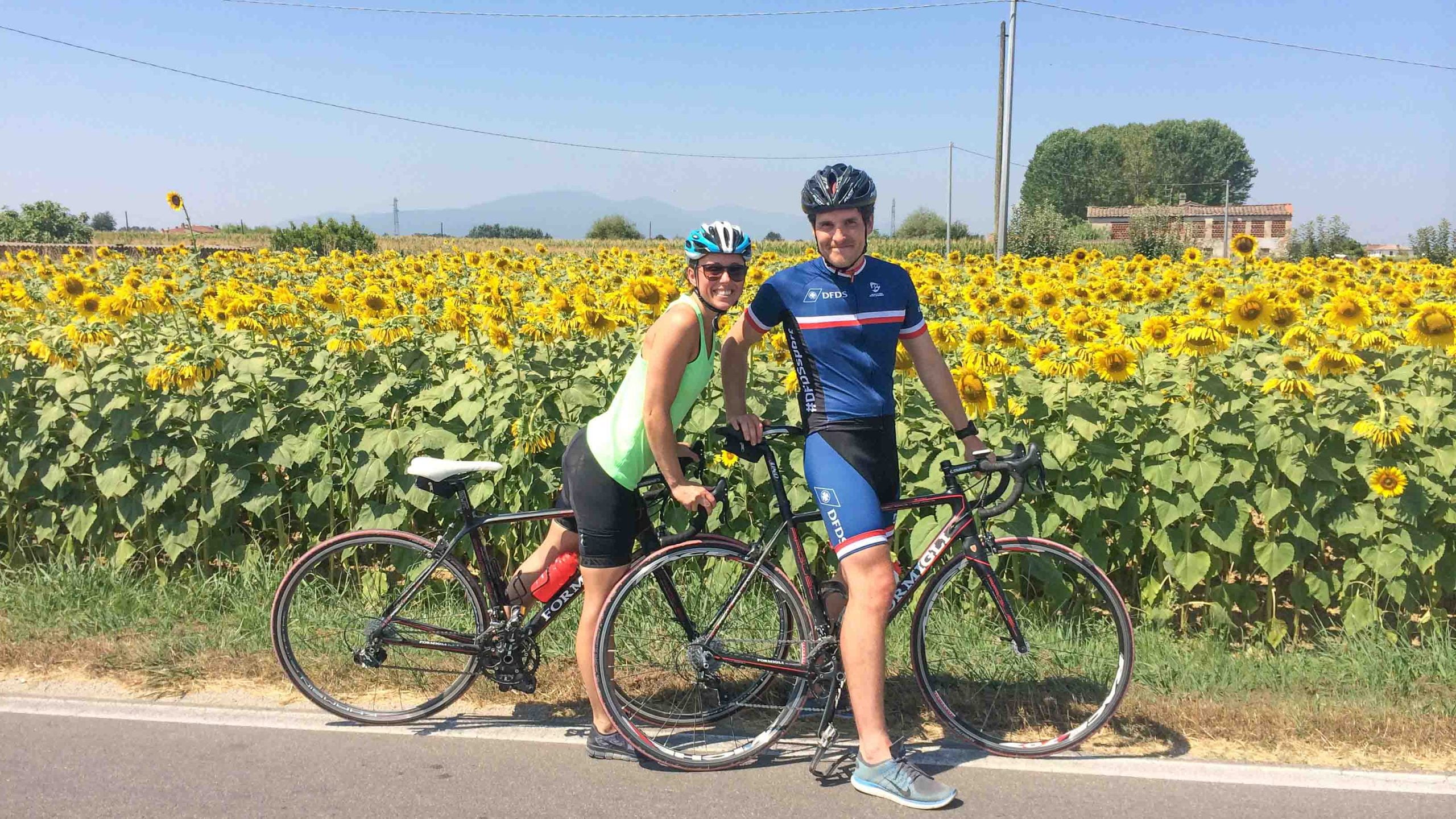 Cyclists in front of sunflowers