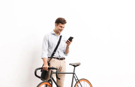 Man with fixie checking bike apps for cyclists