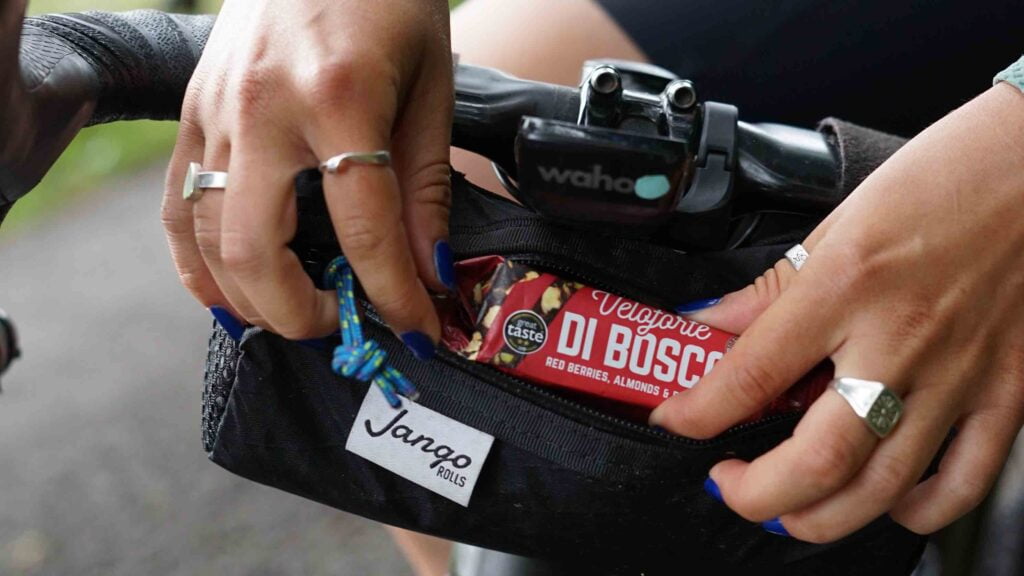 Cyclist getting a bar from their saddle bag