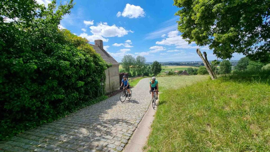 Two cyclistscycling up the Paterberg in Flanders