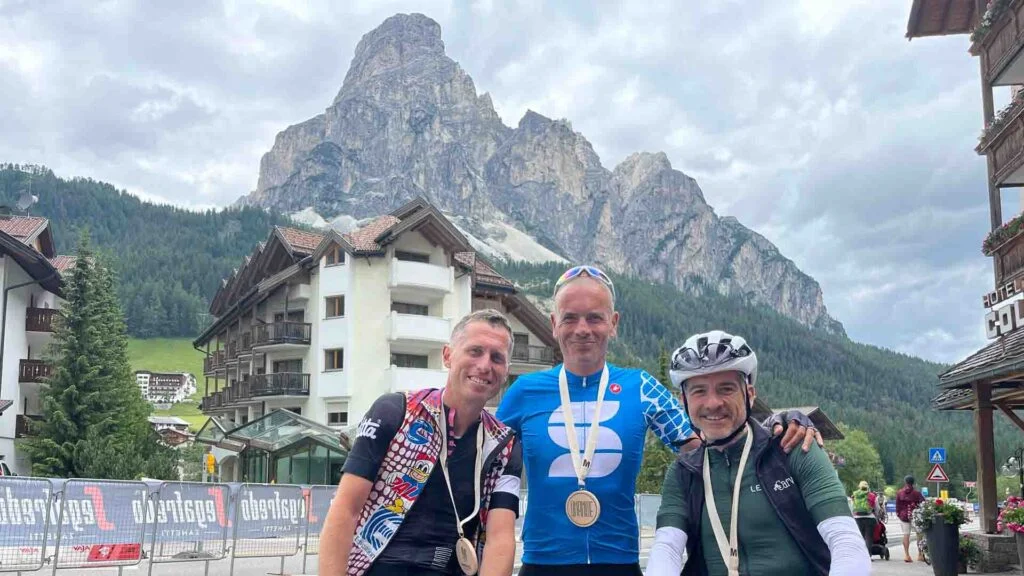 Cyclists wearing medals having completed the maratona dles dolomites