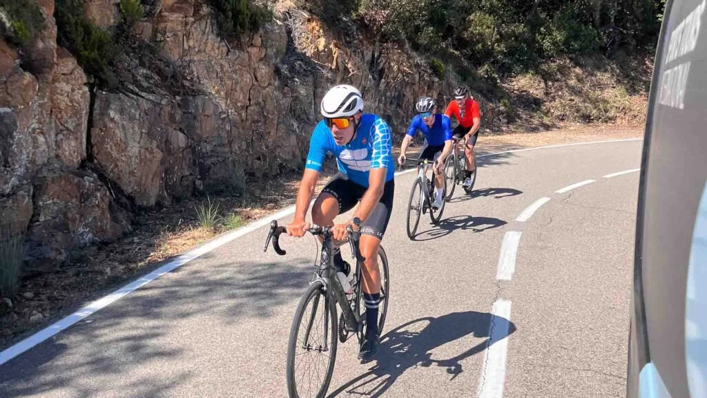 Cyclists climbing a steep climb with Sports Tours International