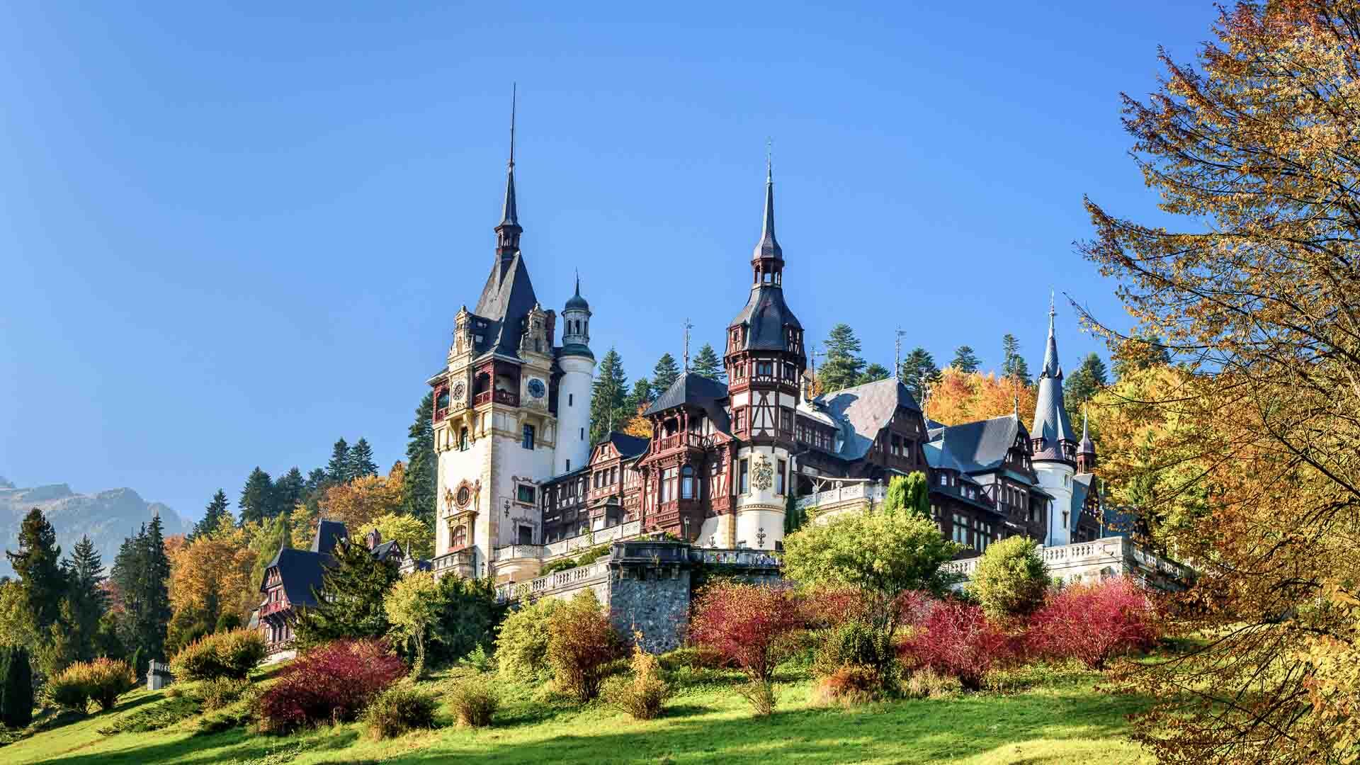 Turrets of Peles Castle in Romania against a blue sky