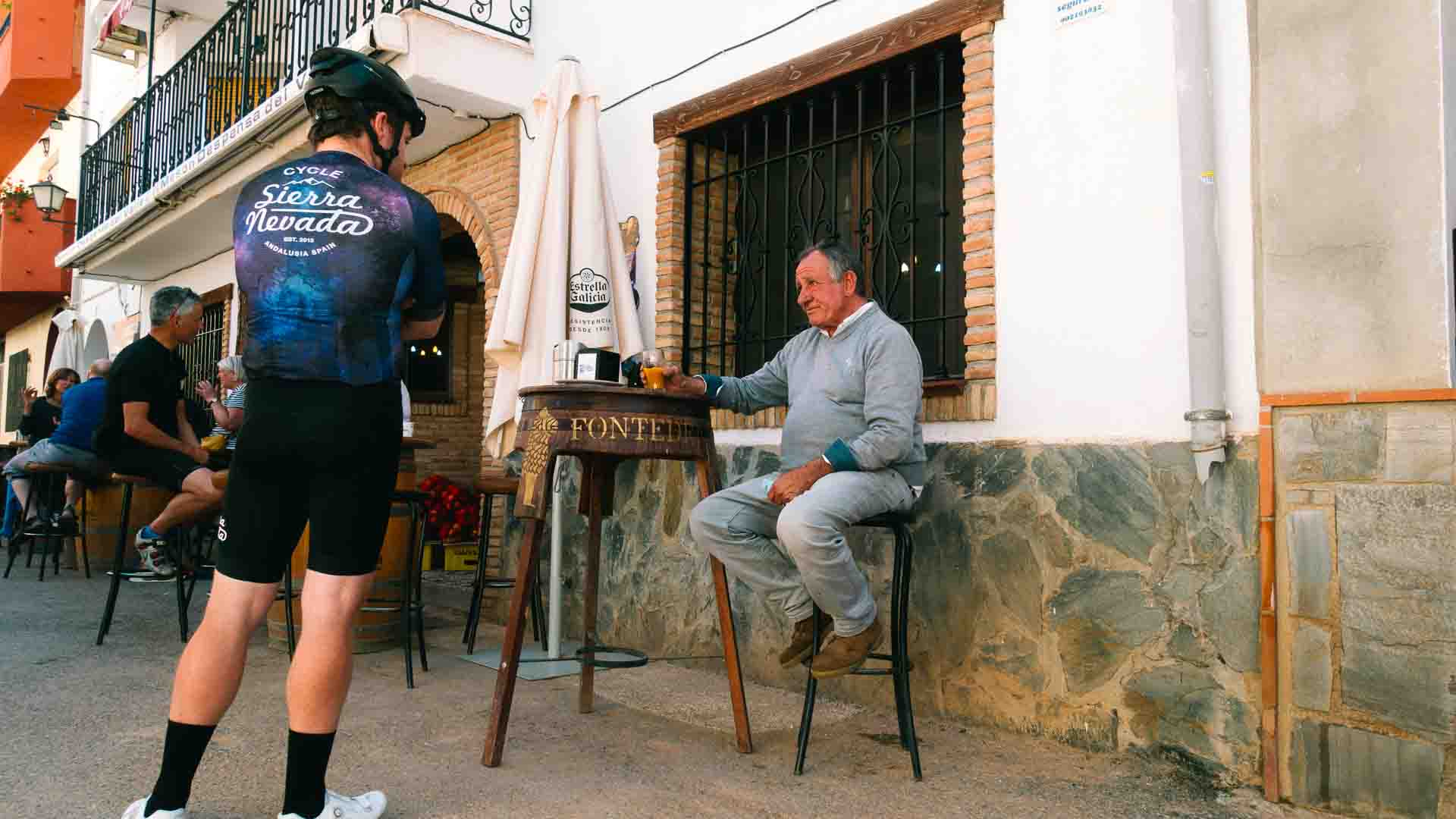 Cyclist talking to a Spanish local in the Sierra Nevada mountains