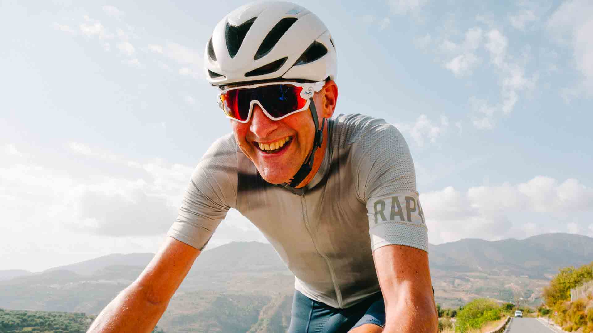 Cyclist smiling in short sleeve top and sunshine in Spain's Sierra Nevada mountains