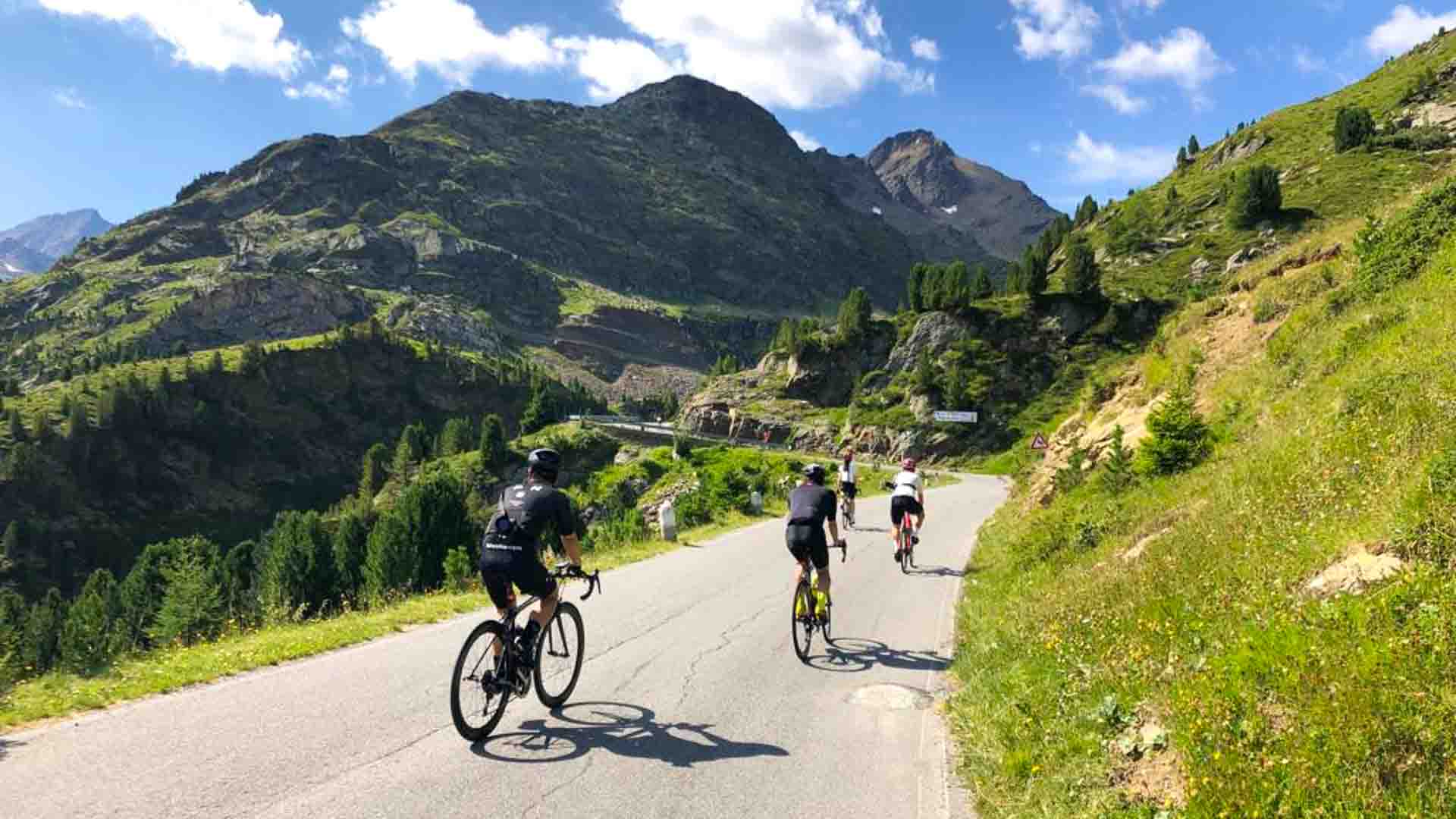 Cyclists cycling from French Alps to Dolomites