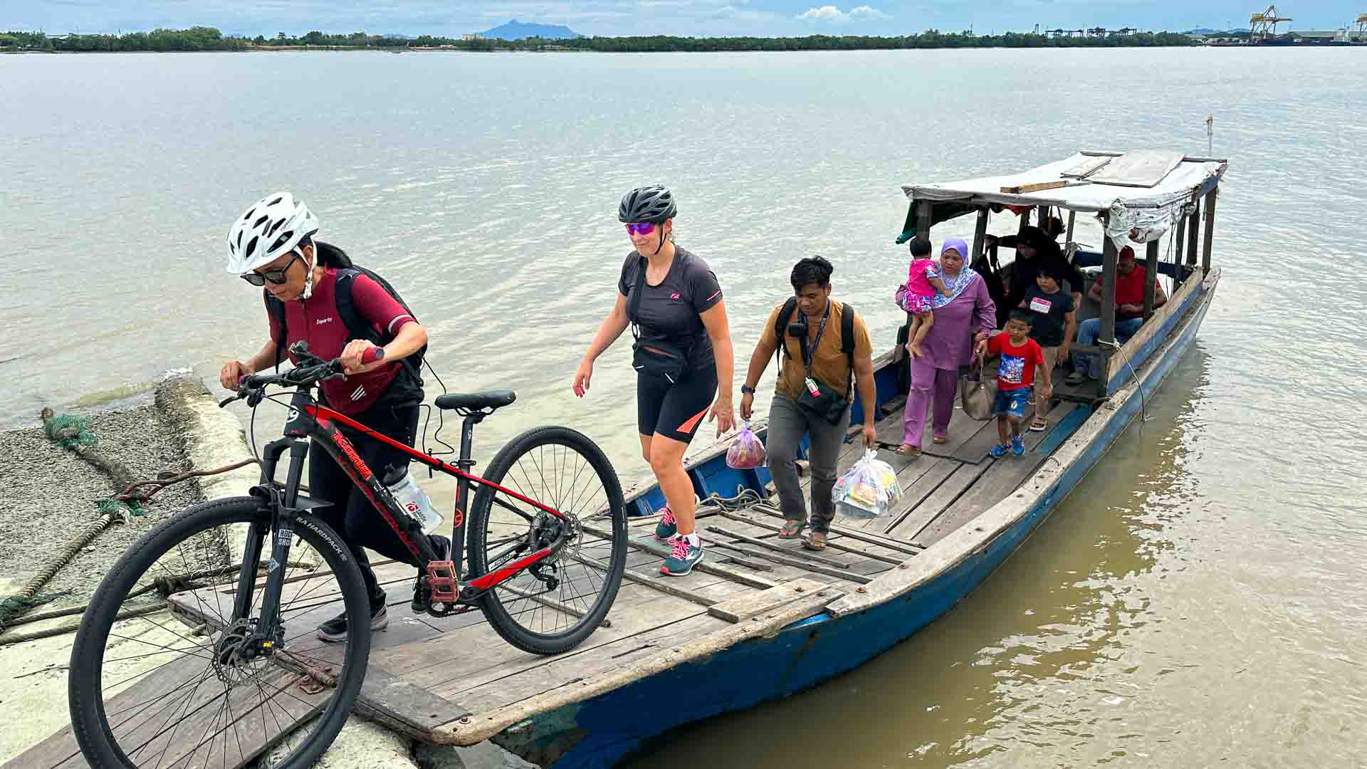 Boat with cyclists and bike unloading