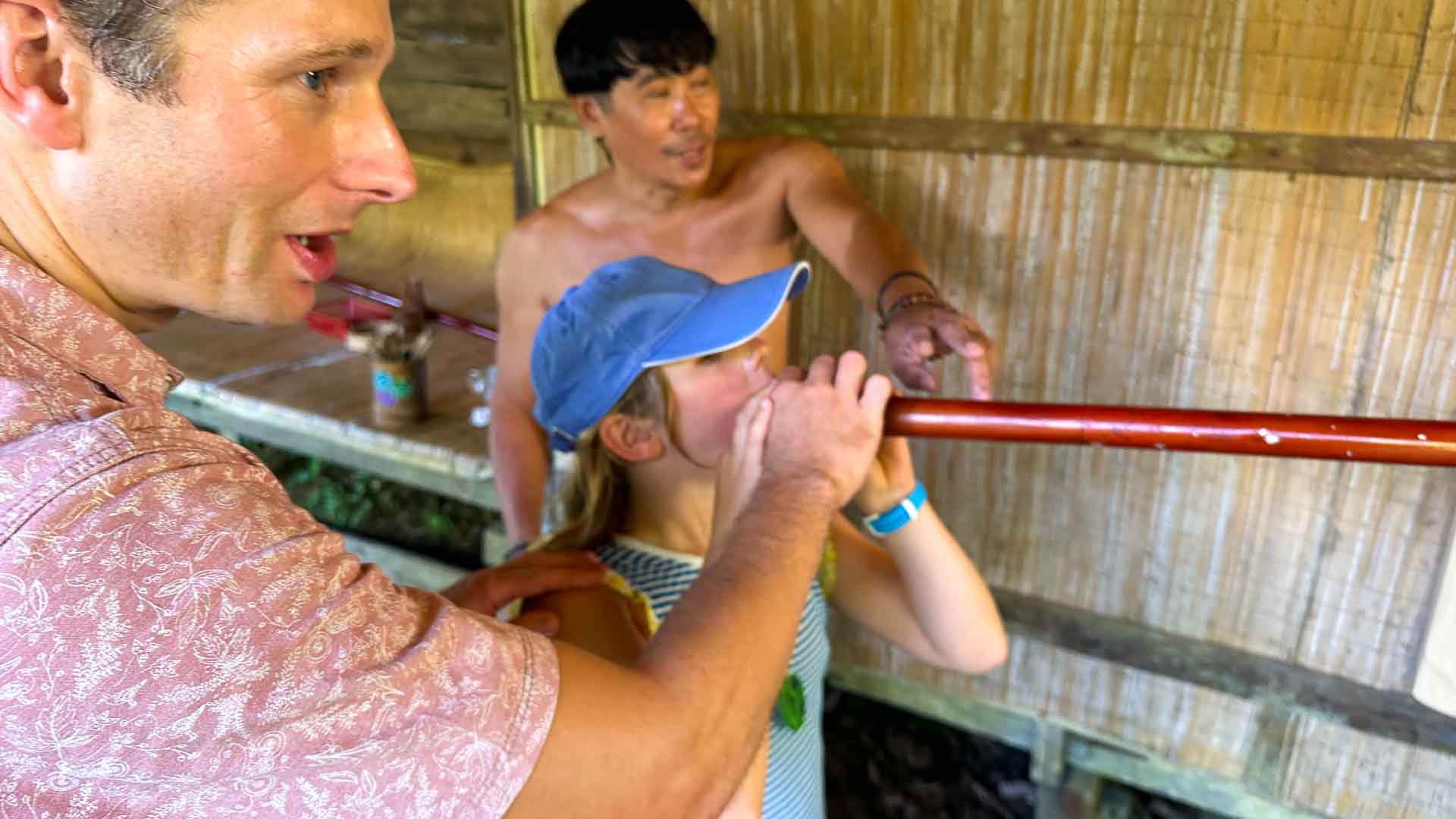 Learning to use blowpipe in Borneo