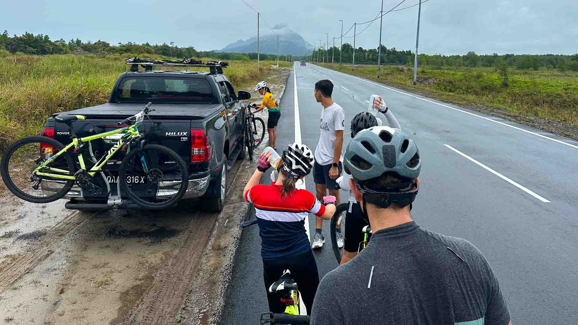 Group of cyclists and support vehicle on a Borneo cycling holiday