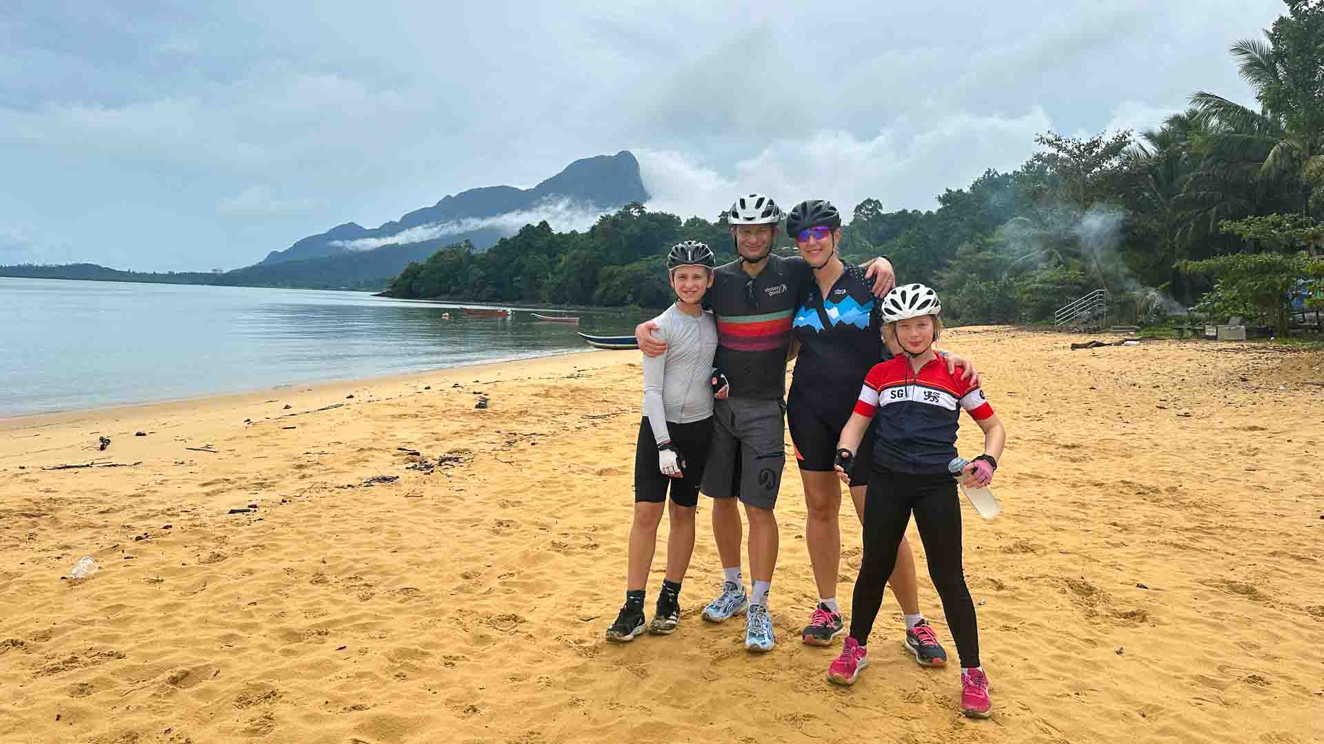 Group of cyclists on a beach in Borneo