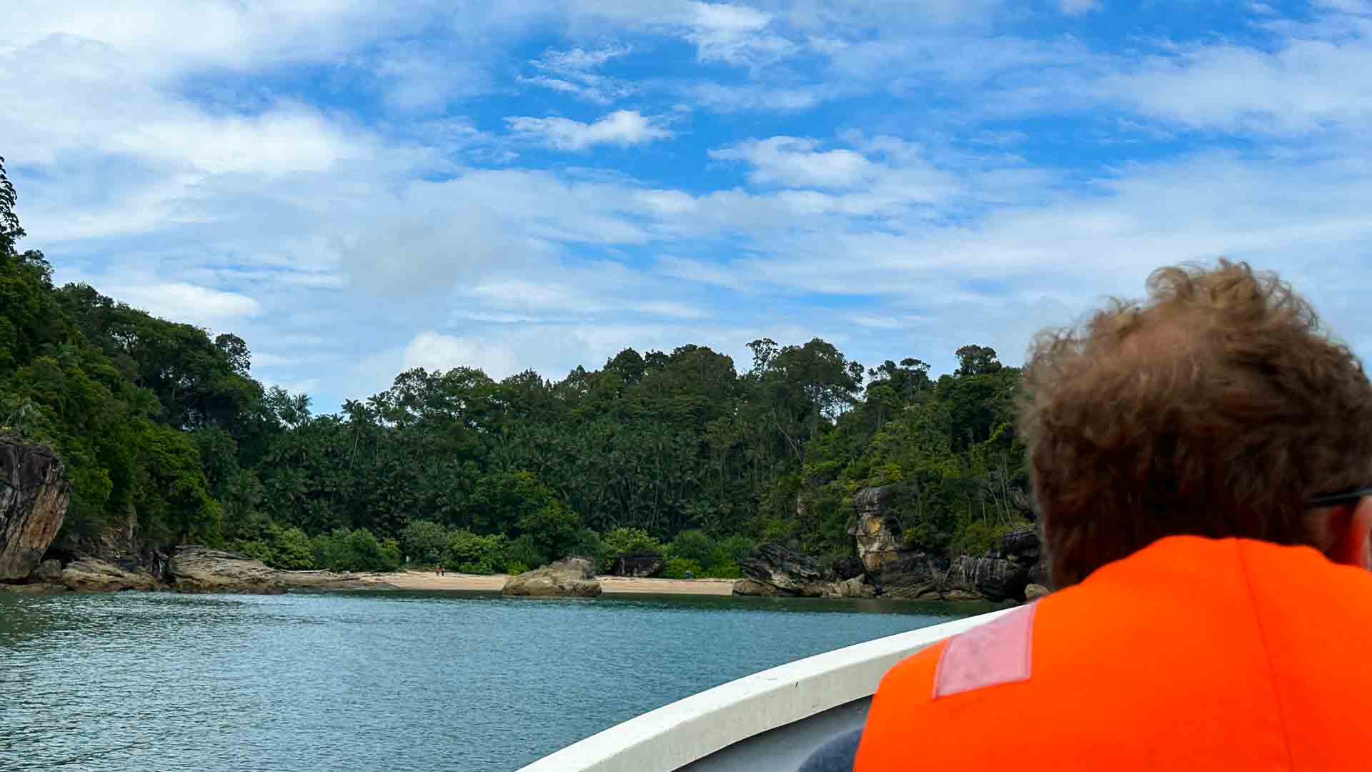 Boat approaching Bako National Park with blue sky
