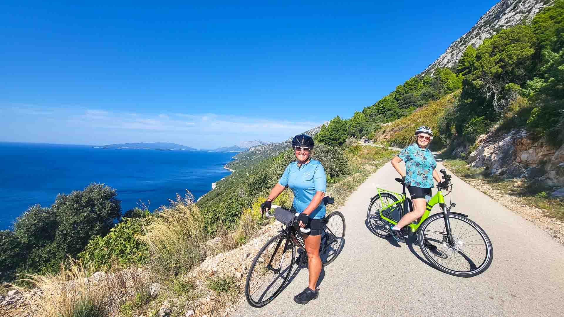 Two cyclists by the sea in Dalmatia, Croatia