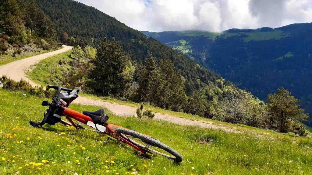 Bike in the Pyrenees mountains with view of gravel trail