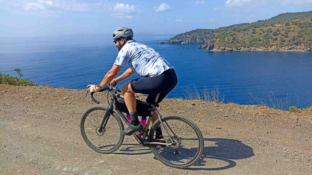 Gravel cyclist by the sea on Girona's Costa Brava coastline