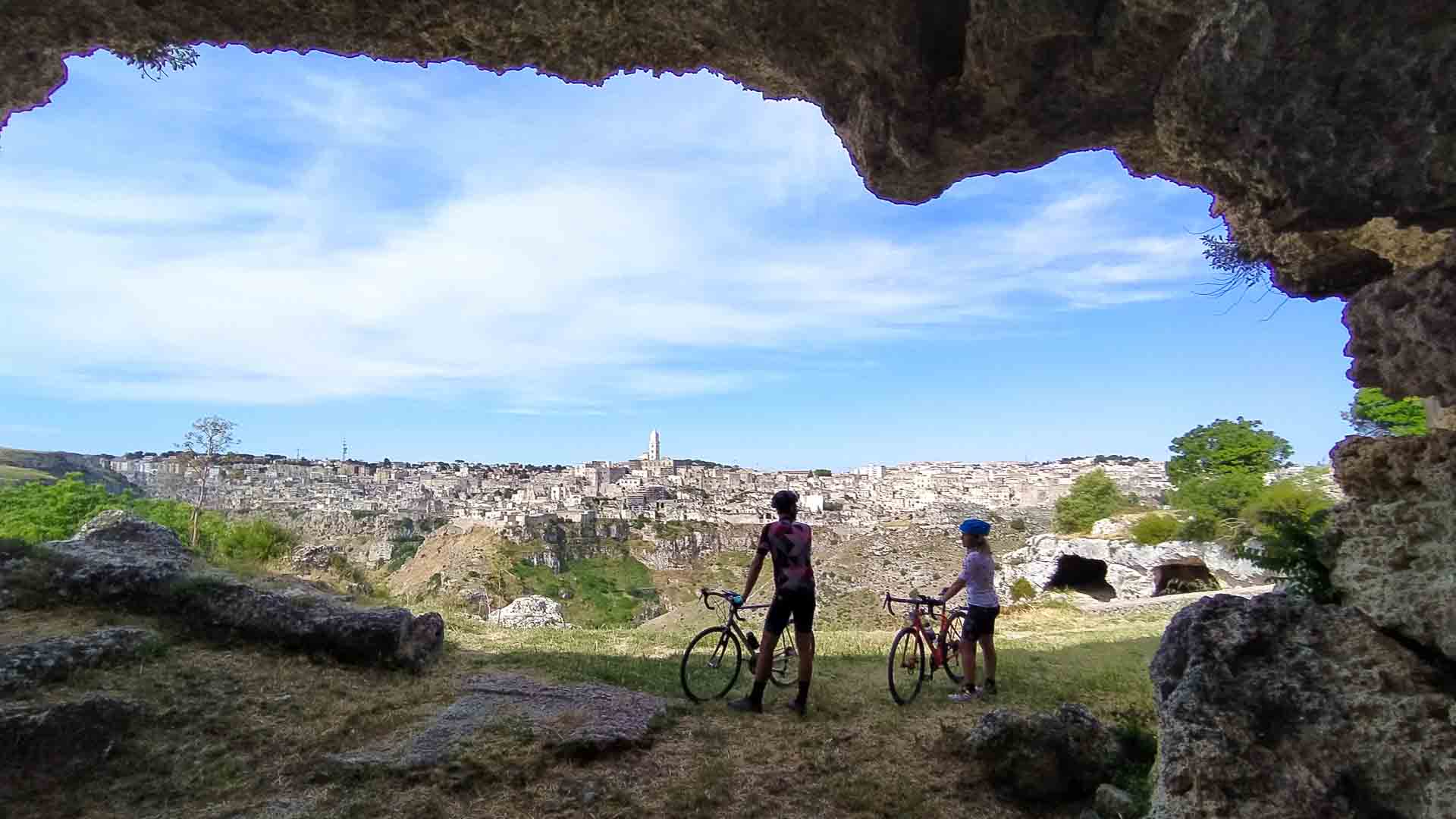 Cyclist overlooking baroque town in Basilicata Puglia Italy