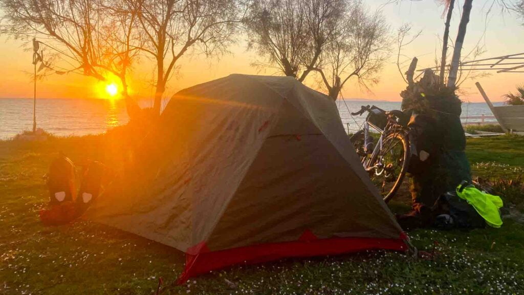 Tent by a lake on a solo cycle tour