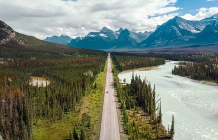 Aerial view of vehicles on scenic Icefields Parkway highway between Banff and Jasper National Parks during summer in Alberta, Canada.