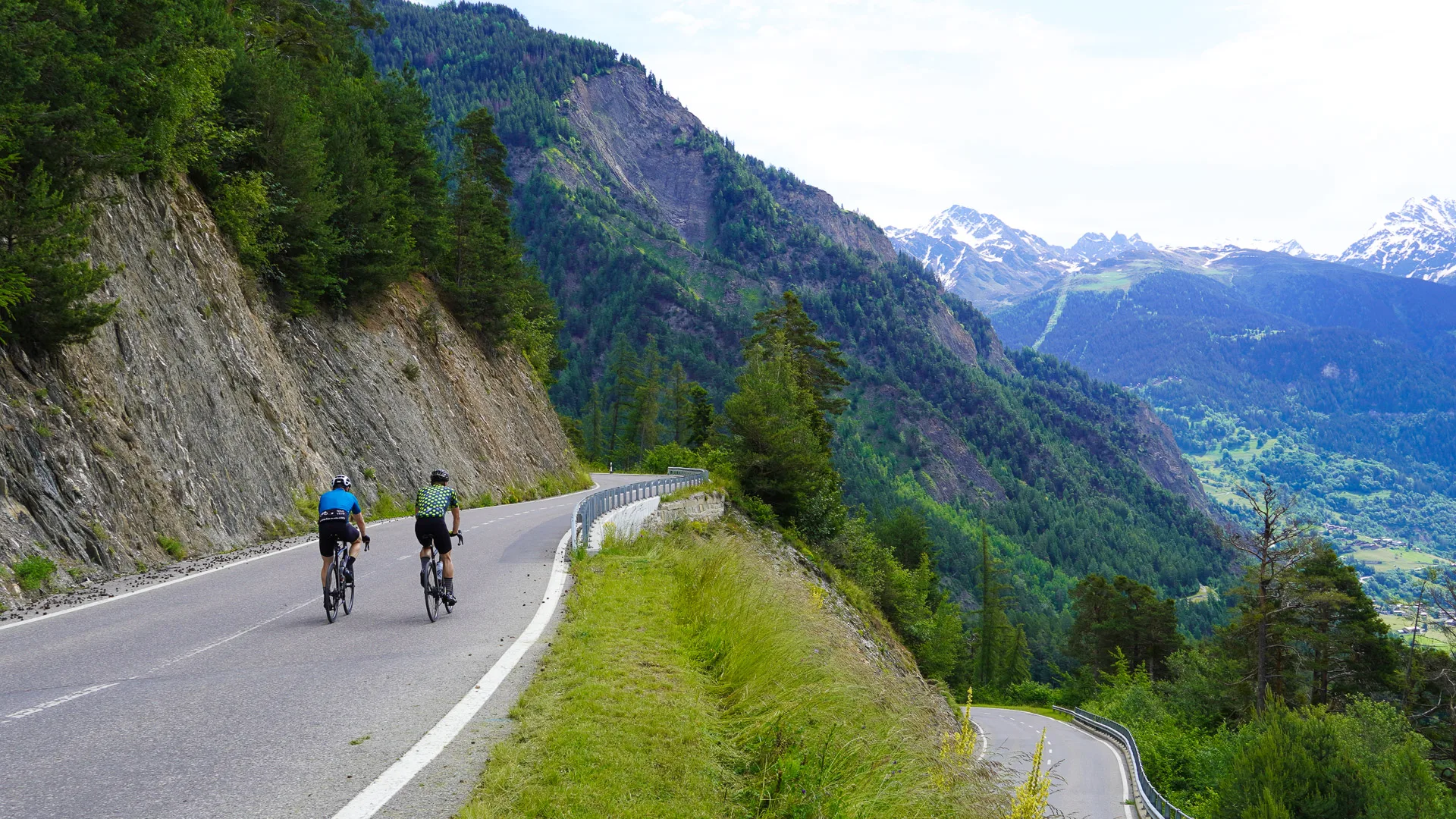 Two cyclists climb the Col du lein, Verbier, Switzerland