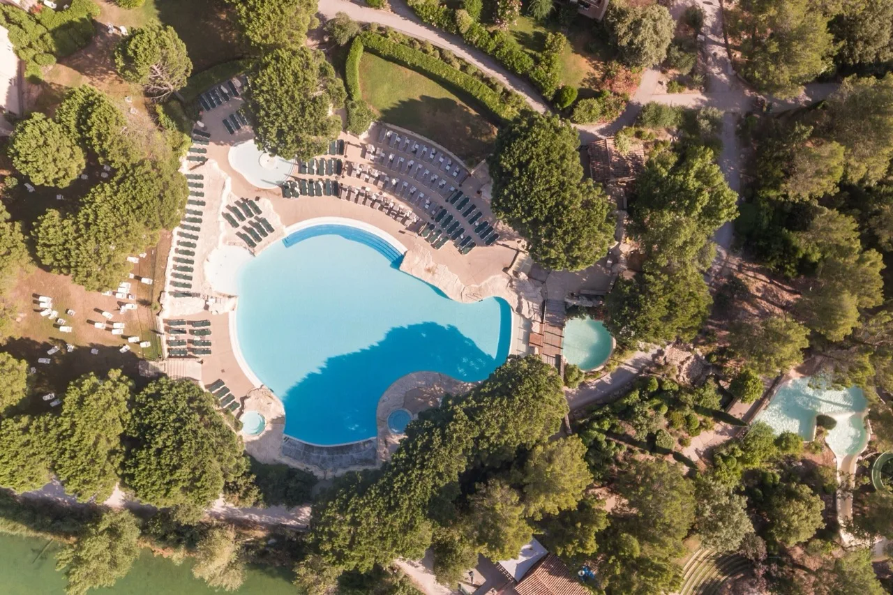 Aerial view of Village Pierre & Vacances Pont Royal en Provence in Mallemort showing pool, sun loungers, and trees