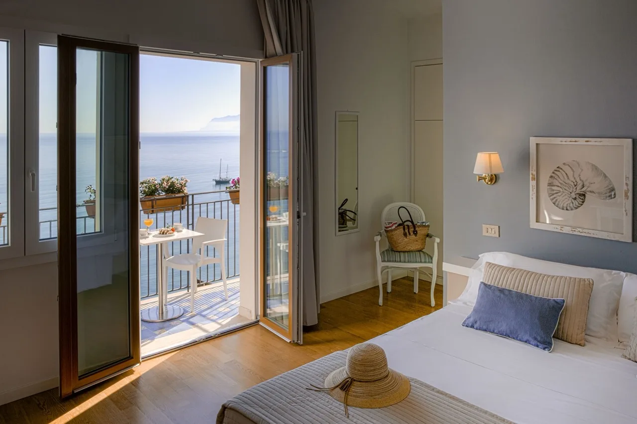 Bedroom at Hotel Punta Nord Est Castellammare del Golfo with balcony and sea view