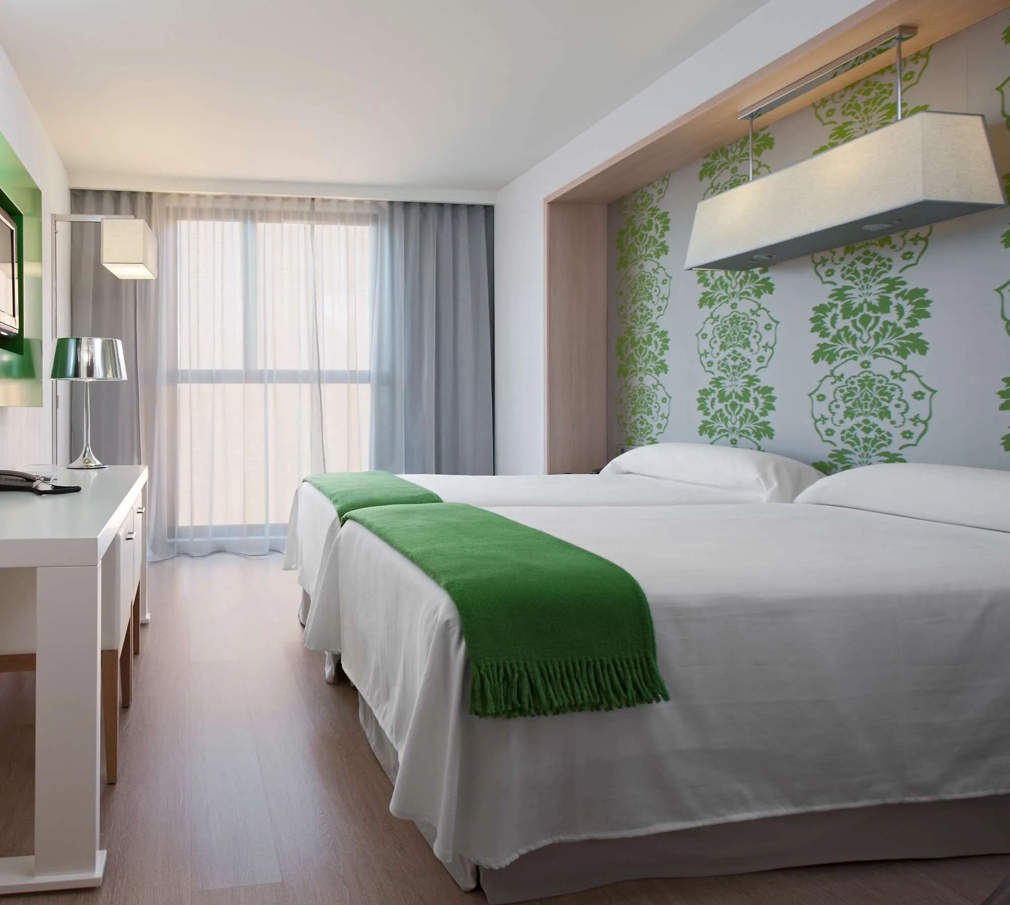 Two-bed room at DoubleTree by Hilton Girona with white and green theme, modern and comfortable setting
