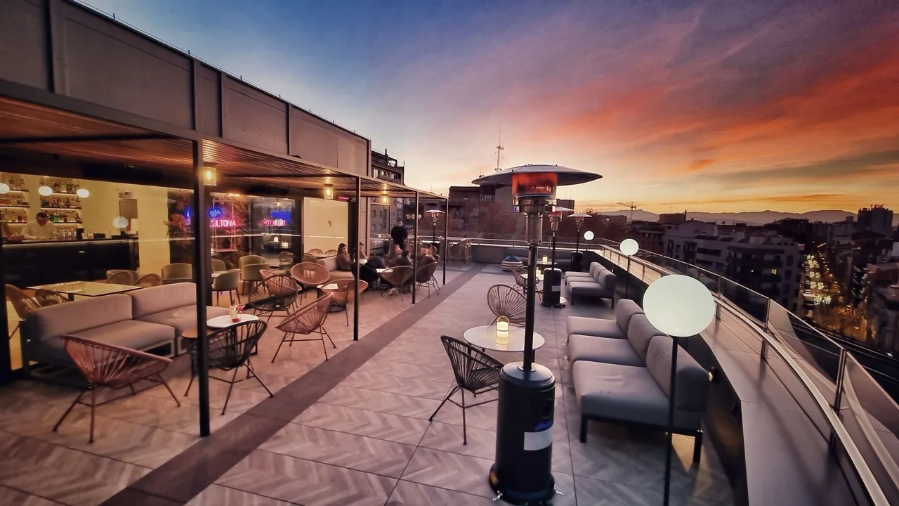 Rooftop terrace at Hotel Ultonia in Girona with seating and panoramic views of Girona Cathedral