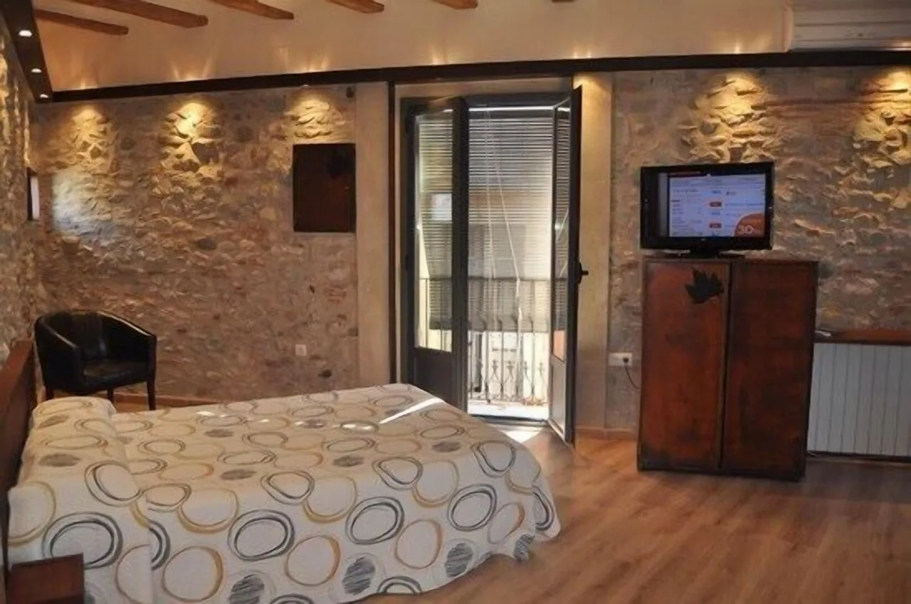 Bedroom at Casa Cundaro in Girona with rustic charm, featuring wooden furniture and traditional decor