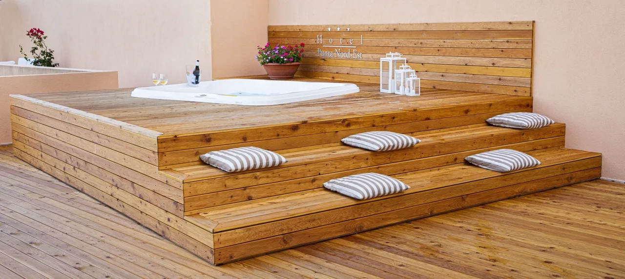 Jacuzzi built into wooden platform and wooden floor at Hotel Punta Nord Est Castellammare del Golfo