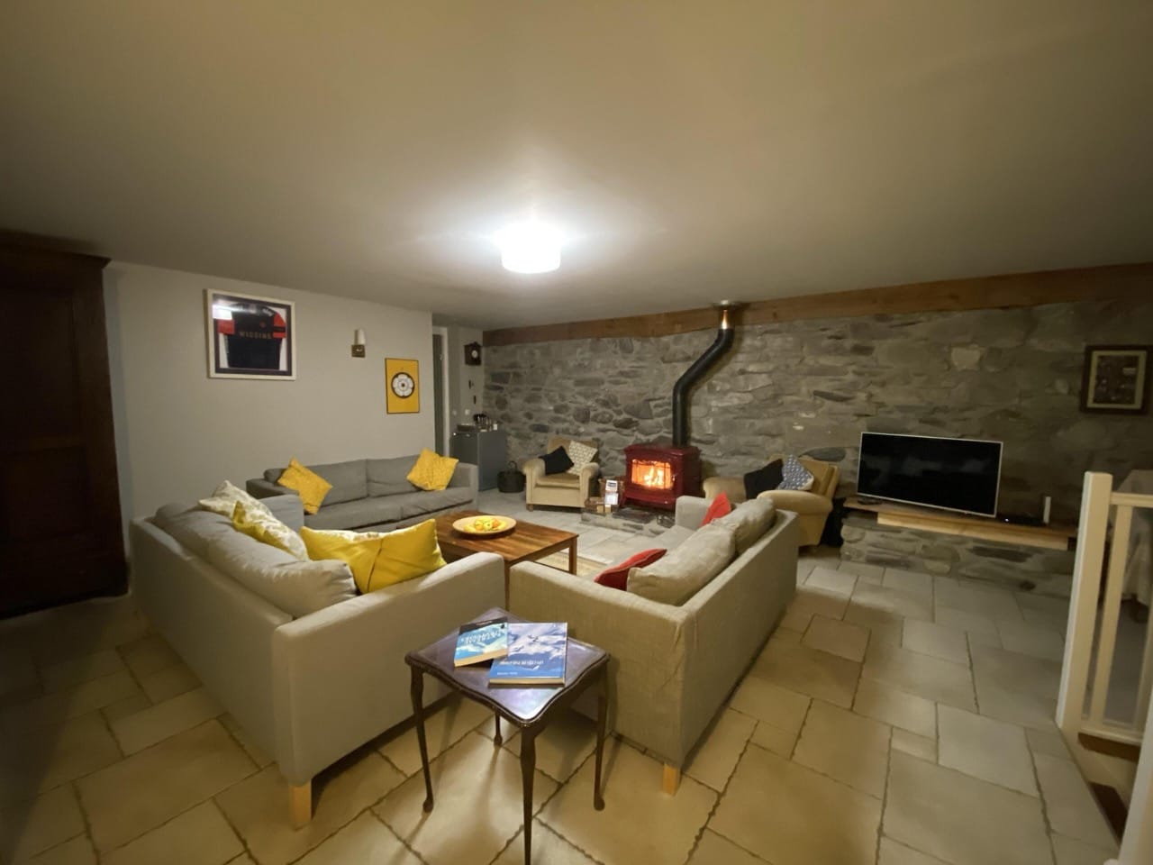Spacious living room at Maison Caramel with rock design walls and classic floor tiles