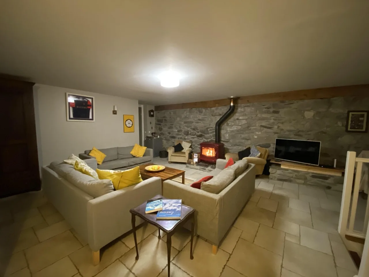 Spacious living room at Maison Caramel with rock design walls and classic floor tiles