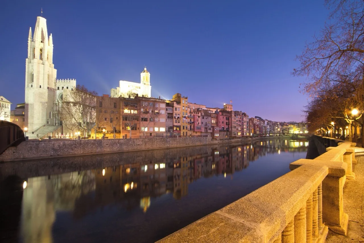 "Outdoor view from Carlemany Girona showing the Onyar River and surrounding rustic buildings in Girona