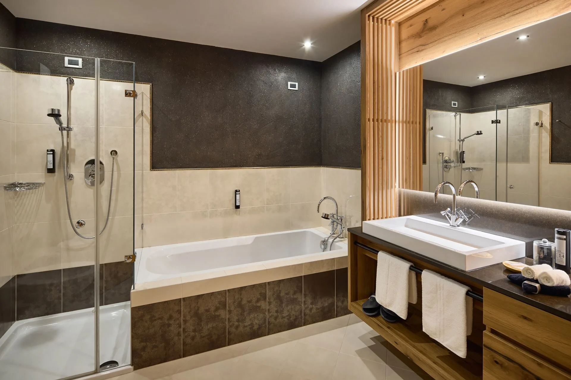 Bathroom at Hotel La Majun in La Villa with dark and white color scheme and modern fixtures