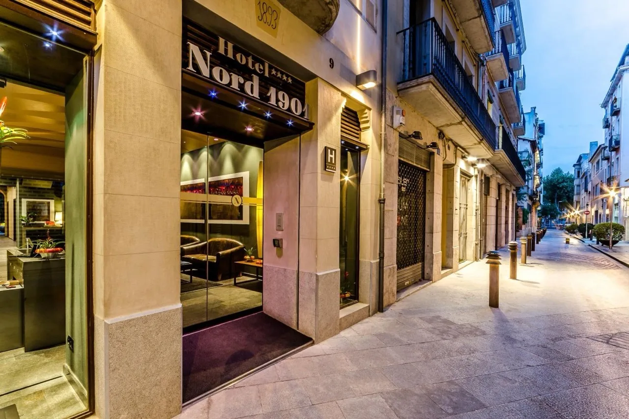Ground floor exterior of Hotel Nord 1901 in Girona with street view and traditional stone facade