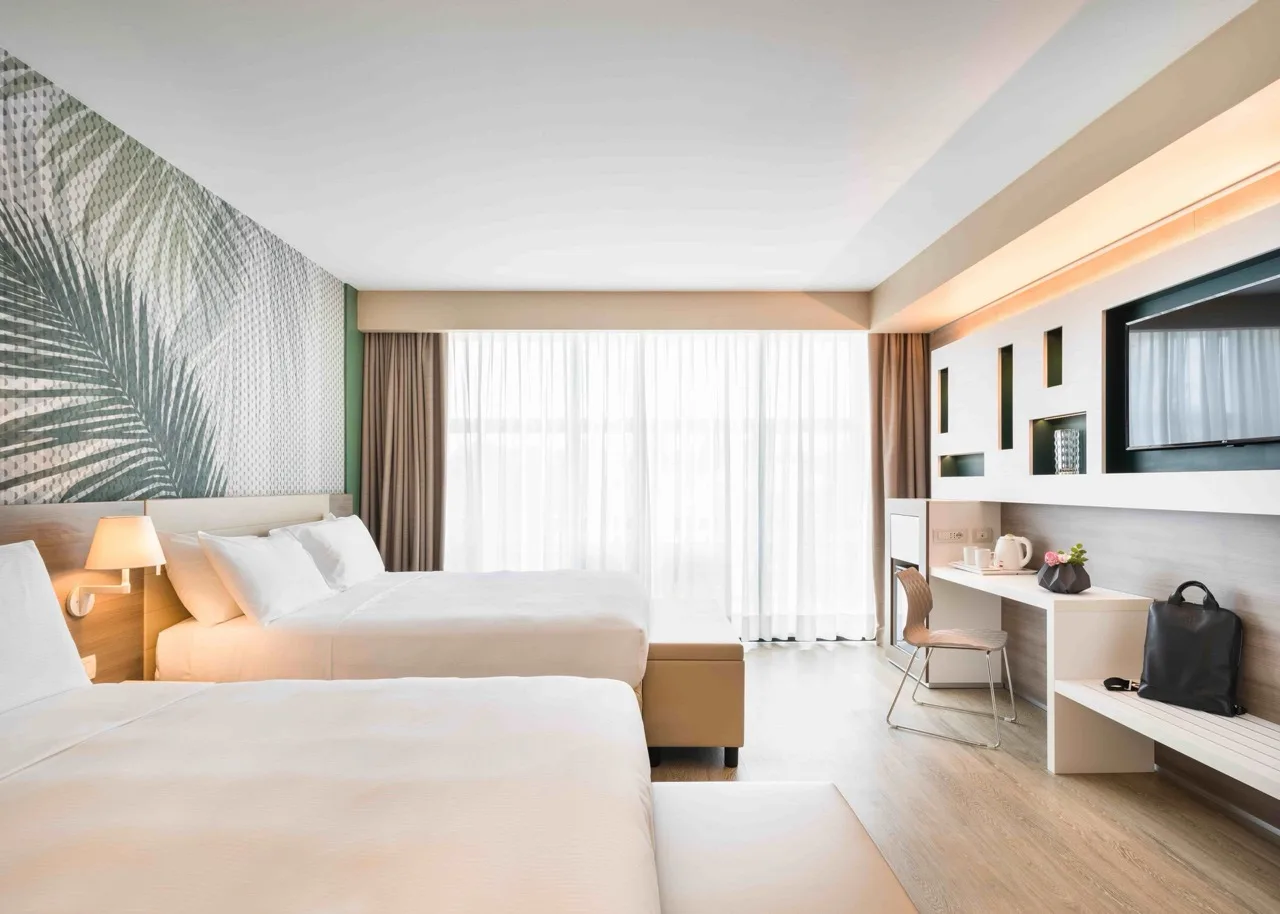 Lake Garda Bike Hotel room featuring twin beds and nature-inspired decor