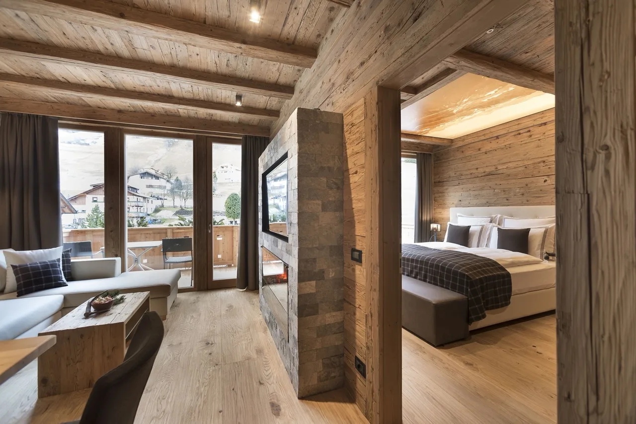 Suite at Hotel Cappella showing living room and peek at bedroom with wood, white, and black accents