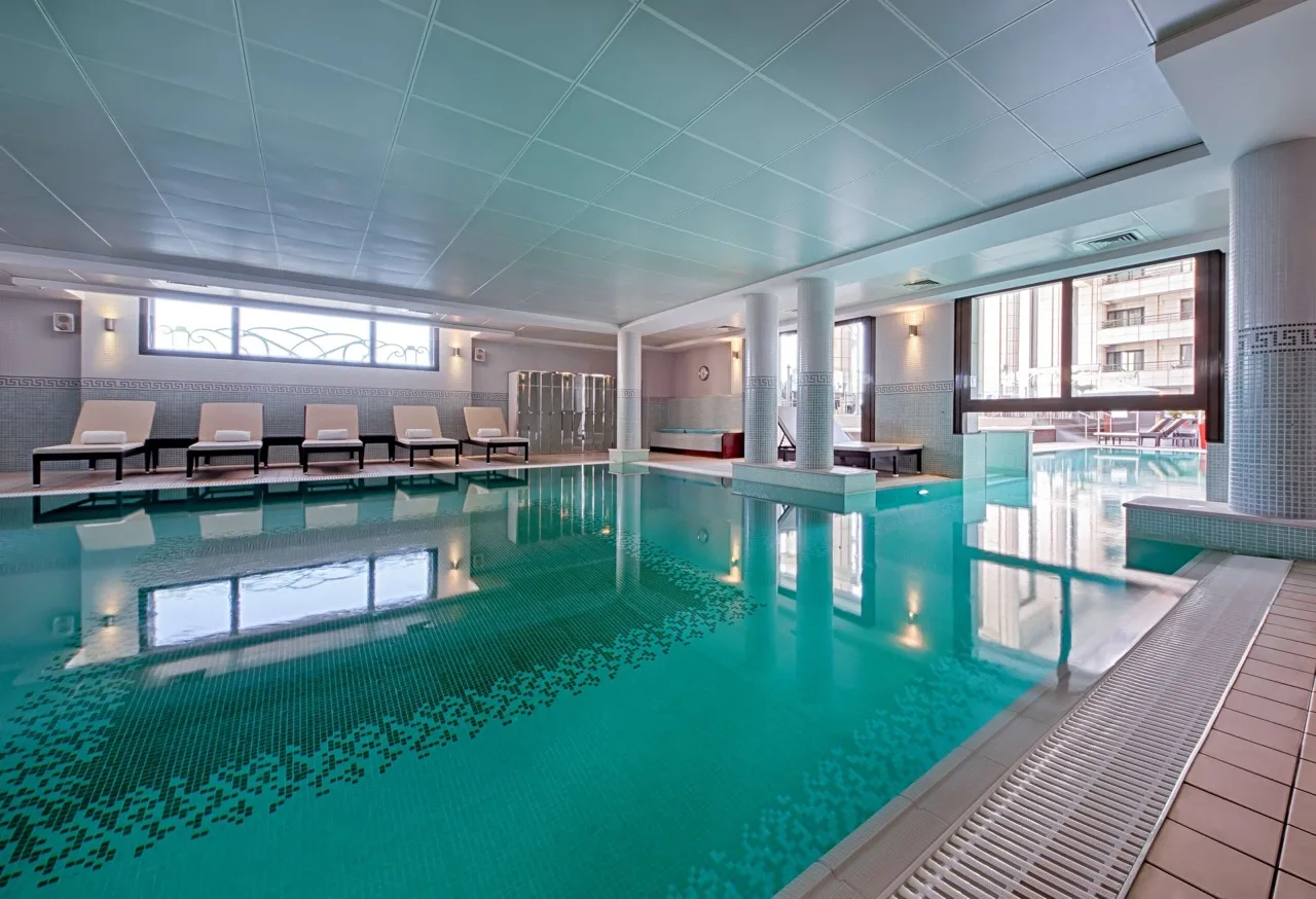 Indoor pool with loungers at Hyatt Regency Nice Palais de la Méditerranée