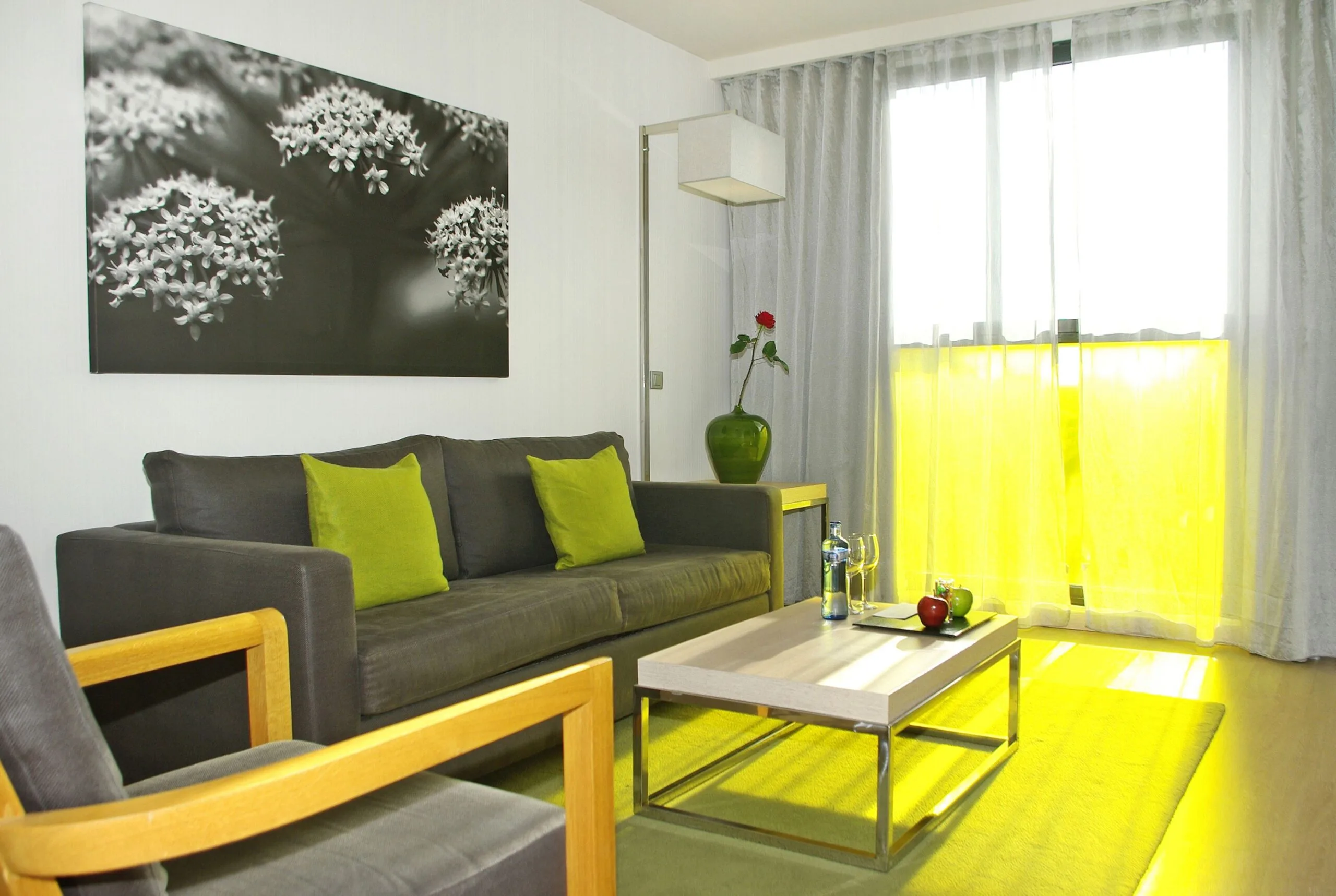 Cozy living room with white walls, gray sofas, and large sliding glass doors at DoubleTree by Hilton Girona