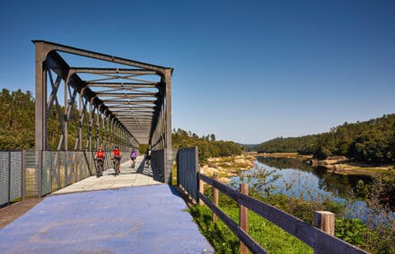 Crossing a bridge over a scenic river on Portugals atlantic ring route