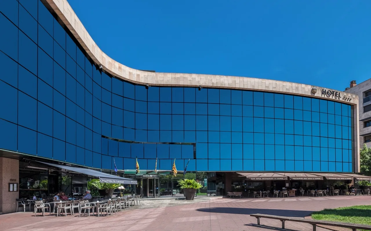Exterior of Hotel Carlemany Girona, showing modern architecture with glass and stone facade in city setting