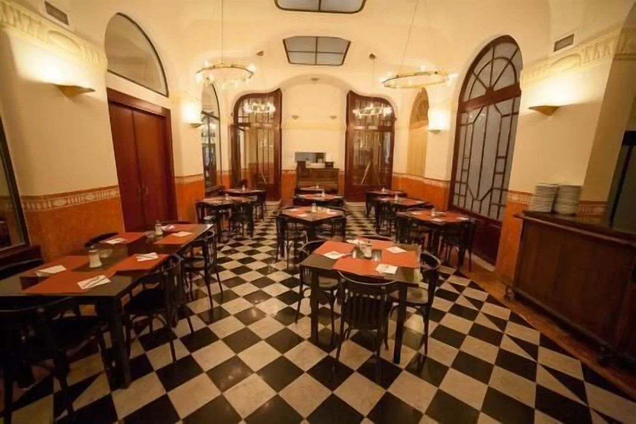 Restaurant at Hotel Peninsular in Girona with checkered tile floor and traditional table settings